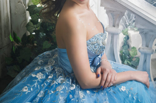 woman in ballgown sitting on stairs